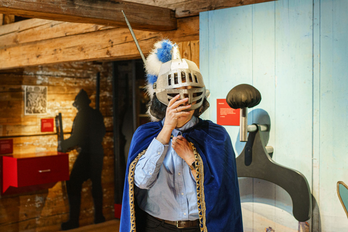 The Knight's Disguise Station: a visitor wearing a knight's helmet.